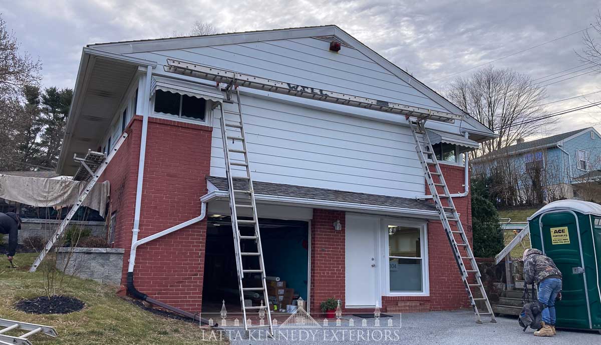 Setting up ladders and planks, as well as protective covering for the new front patio. The garage roof overhang was also protected, but not pictured above. 