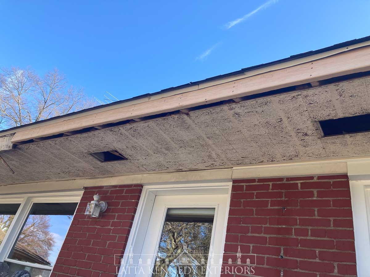 Removal of existing soffit and installation of new flush, fascia boards. This was completed by sistering new framing lumber to existing rafter tails and installing new fascia boards on top.