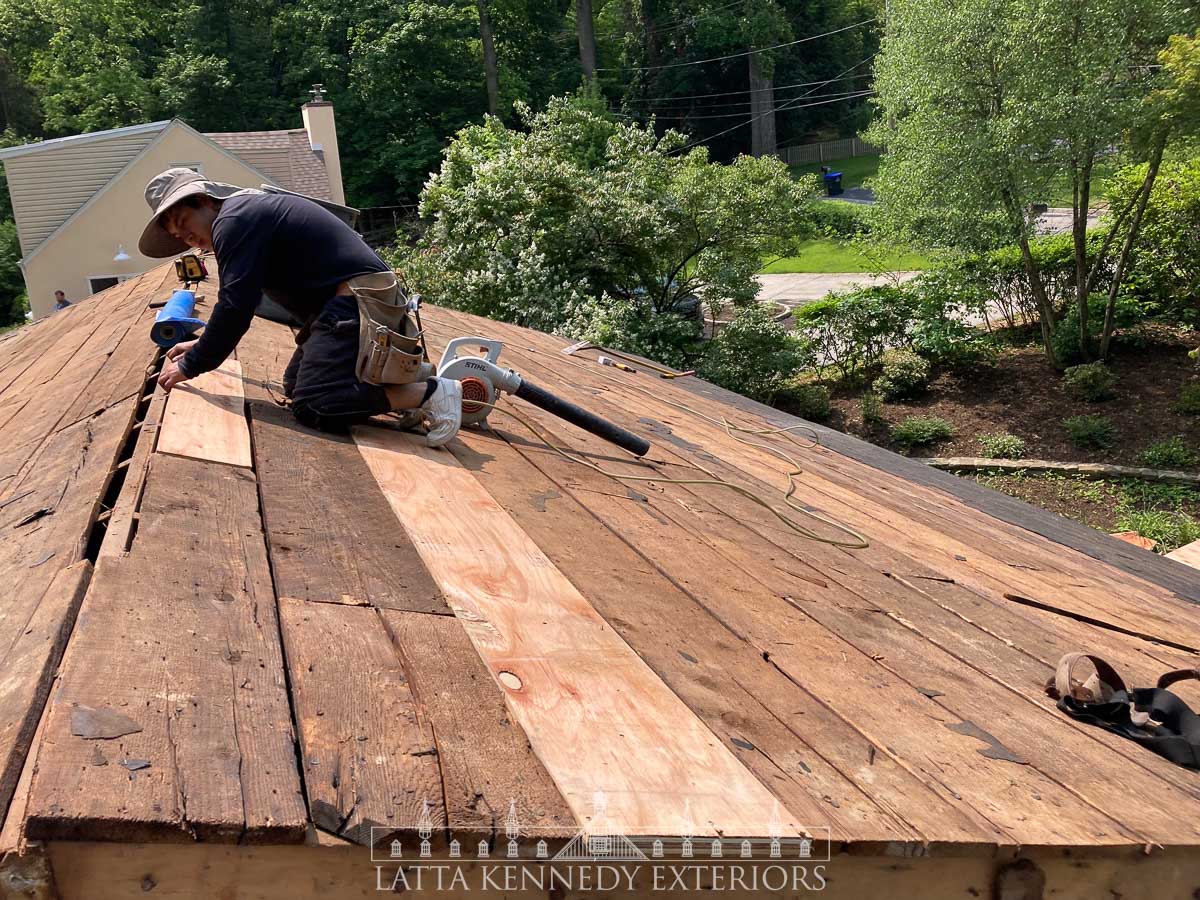 Careful removal of existing asphalt shingles and sheathing integrity inspection. 